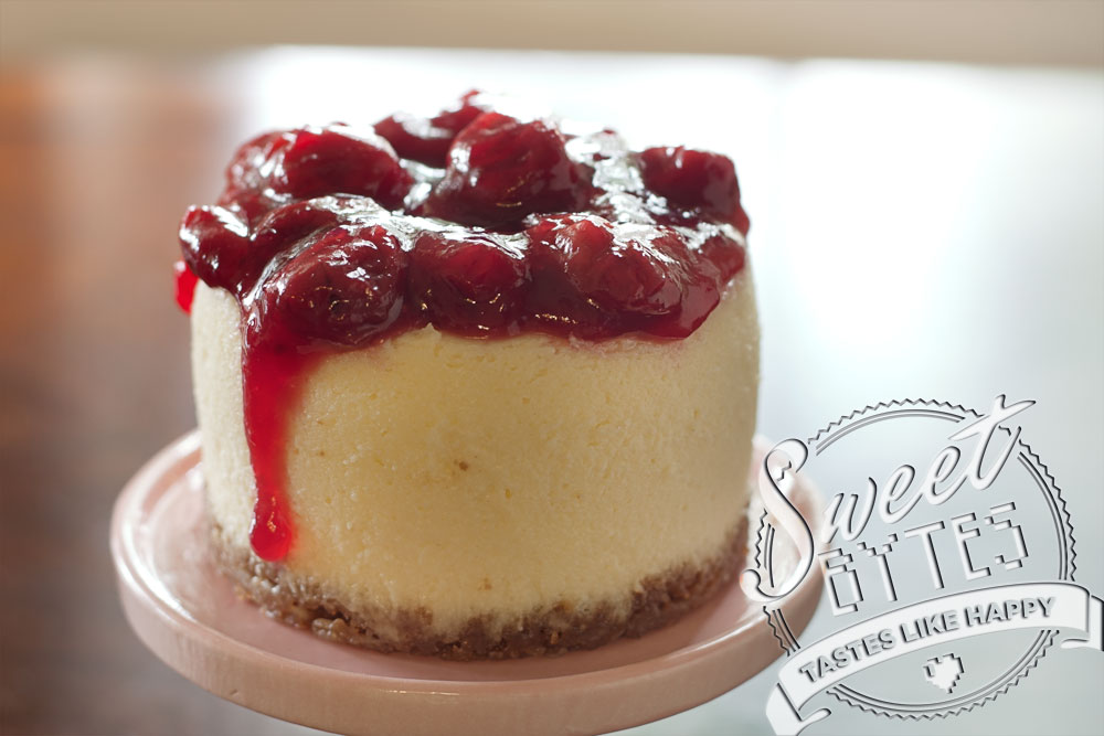 A mini-cheesecake with cherry topping dripping down the left side for article about baking terminologyl