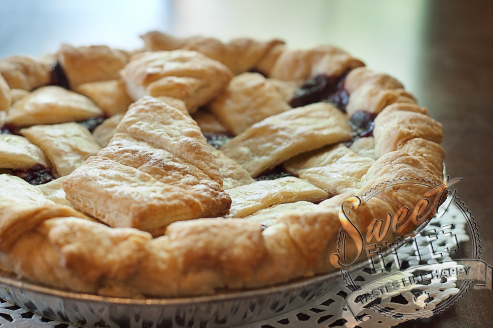 A triple berry pie with a pie crust cut out in the shape of a man's tie