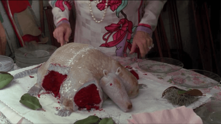 red velvet cake shaped like an armadillo with slices removed to expose red cake