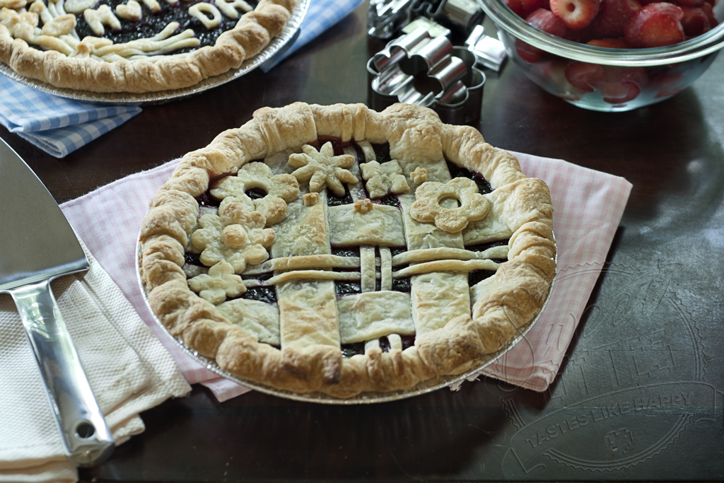 decorated triple berry pie with lattice crust and cut out flowers on top