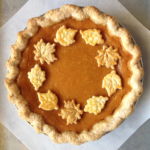 Overhead picture of pumpkin pie with a circle of pie crust leaves for decoration