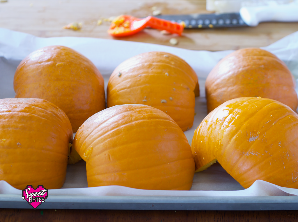 Pumpkins for pie cut in half and arranged on a baking sheet