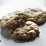 3 big triple chocolate chunk cookie arranged on a white parchment paper after baking cookies