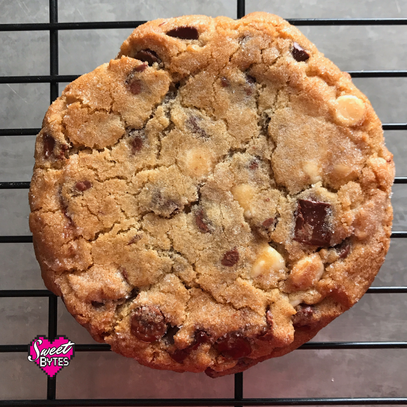 A close up view of a large triple chocolate chunk cookie 