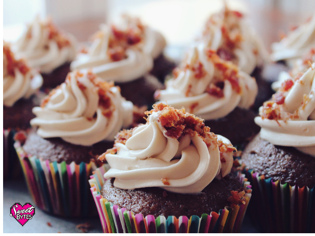 Cupcakes with swirled frosting and candy sprinkled on top.