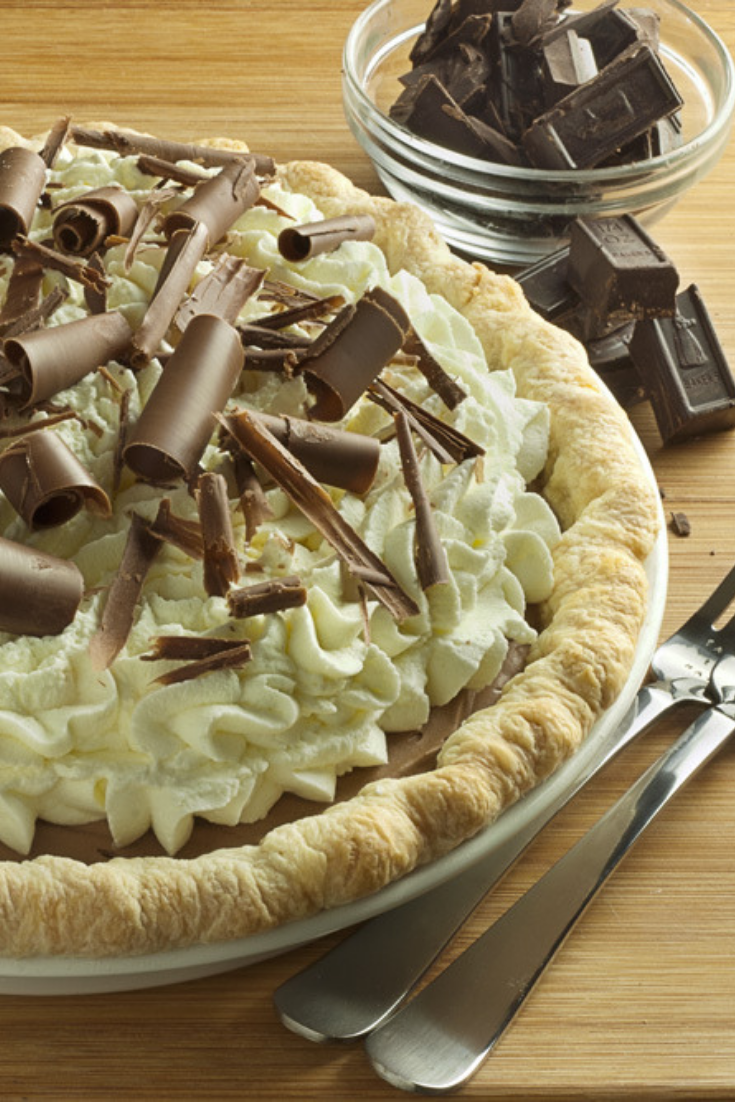 Close up of French Silk Pie with whipped cream and chocolate curls