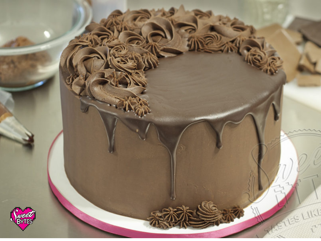 A chocolate cake covered in chocolate ganache
