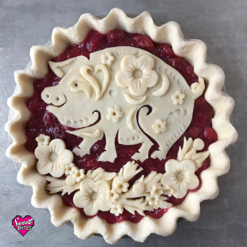 Unbaked pie with decorative pig and flowers for Lunar New Year 