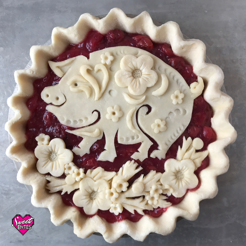 Unbaked pie with decorative pig and flowers for Lunar New Year