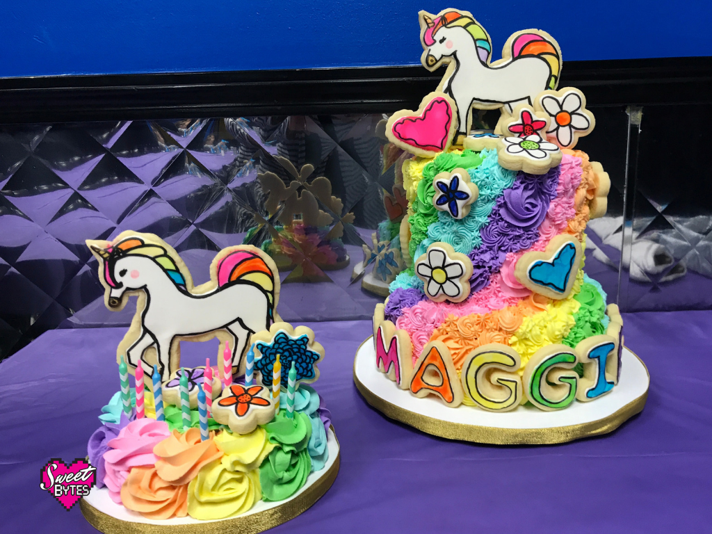 2 unicorn cakes with rainbow colored buttercream 