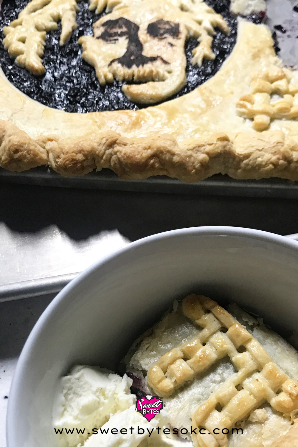Close-up of a white bowl filled with a slice of blueberry pi day pie with a scoop of vanilla ice cream melting next to it. Einstein pi day pie is in the backgound.