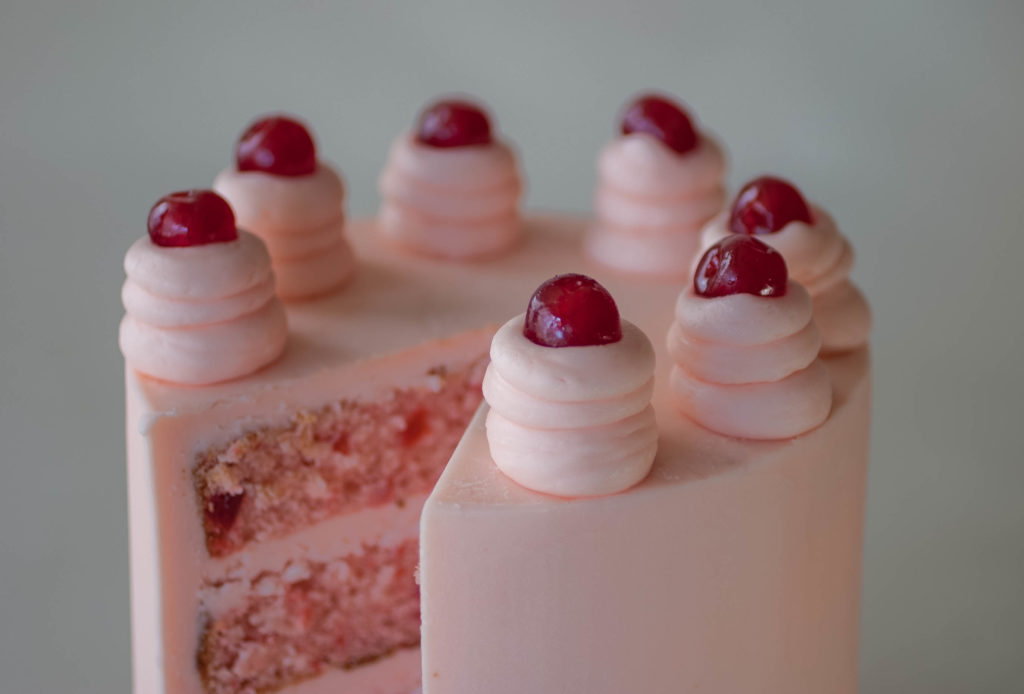 Top of cherry chip cake with pink cherry buttercream