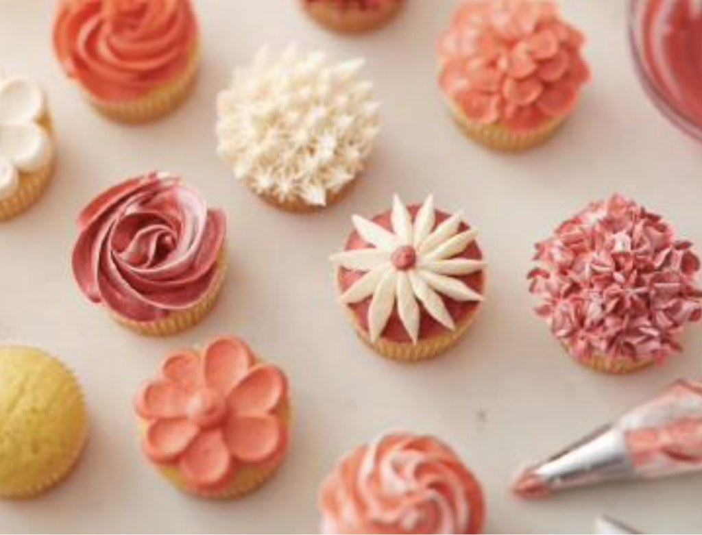 A variety of cupcakes with floral decorations